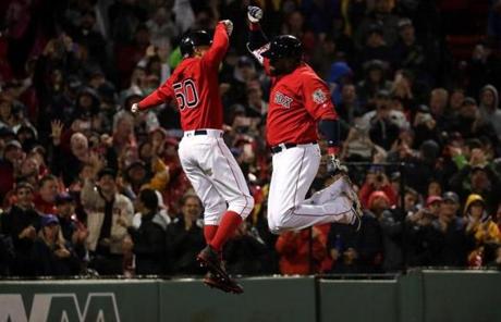 Boston Red Sox designated hitter David Ortiz and Boston Red Sox right fielder Mookie Betts celebrated with a leaping fist bump after Ortiz's two-run home run during the seventh inning.
